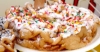 funnel-cake-with-powdered-sugar-cream-and-sprinkles-on-top